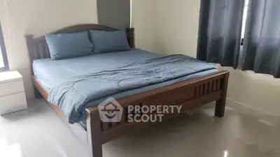Spacious bedroom with elegant wooden bed and modern decor