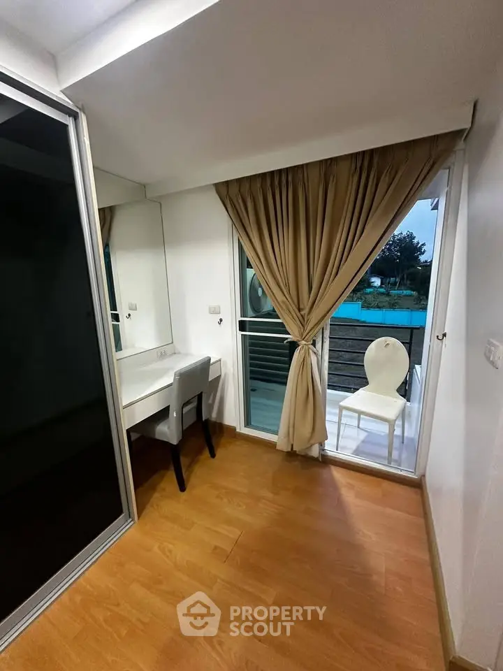 Chic study room with balcony access and elegant decor in modern apartment.