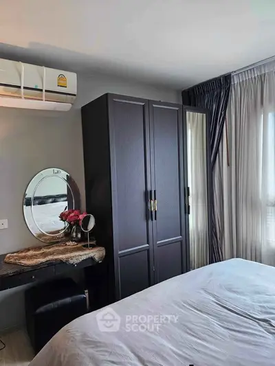 Cozy bedroom with modern wardrobe and stylish vanity in a well-lit space.