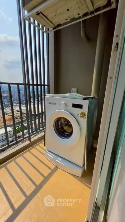 High-rise balcony with washing machine and city view, perfect for urban living convenience.