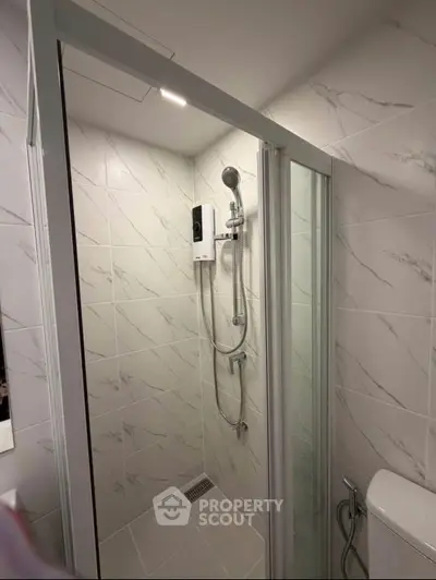Modern bathroom with sleek shower enclosure and elegant tile design.