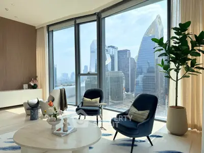 Luxurious living room with stunning city skyline view through floor-to-ceiling windows.