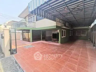 Spacious covered patio area with tiled flooring and modern design.