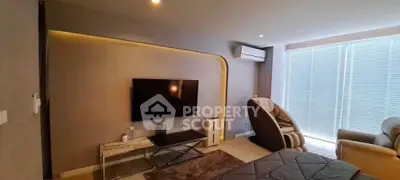 Modern living room with sleek TV setup and massage chair