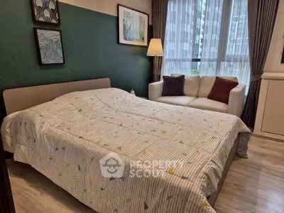 Cozy bedroom with modern decor, featuring a comfortable bed, stylish sofa, and large window with city view.