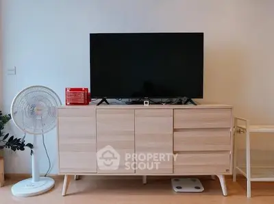 Modern living room with sleek TV stand and fan, perfect for cozy entertainment.