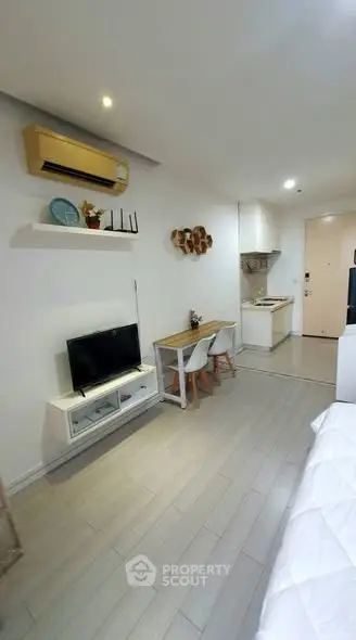 Modern studio apartment with sleek design and compact kitchen
