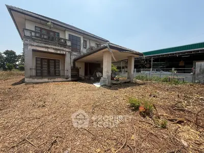 Charming two-story house with rustic appeal and spacious yard, perfect for renovation enthusiasts.