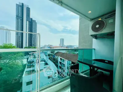 Modern balcony with city view and outdoor seating, perfect for relaxation.