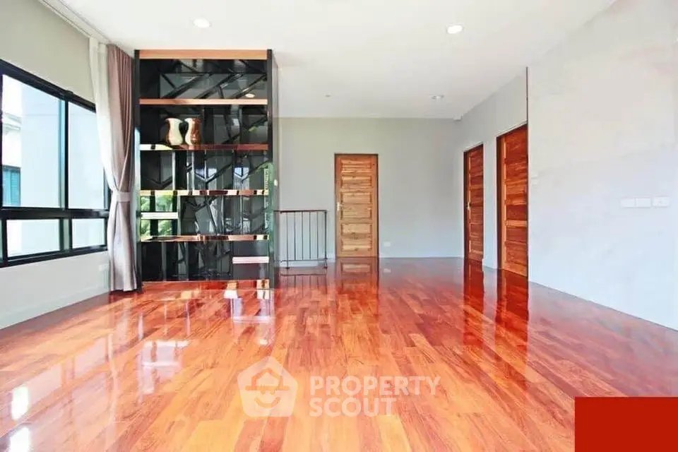 Spacious living room with glossy wooden floors and modern decor