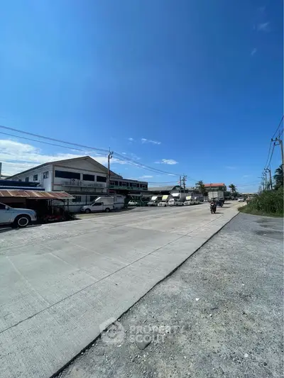 Expansive industrial area with clear blue skies, showcasing potential for commercial development.