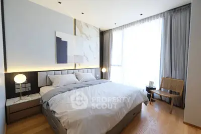 Luxurious bedroom with modern decor and large window for natural light
