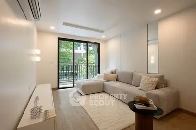 Modern living room with cozy sofa and balcony view in a stylish apartment.