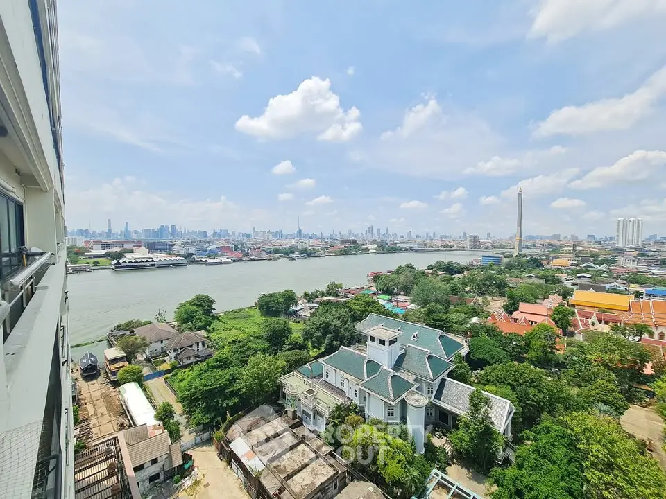 Stunning panoramic cityscape view from high-rise building overlooking river and skyline.