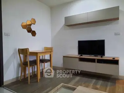 Modern living room with sleek furniture and wall-mounted TV