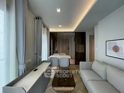 Modern living room with sleek furniture and elegant lighting in a contemporary apartment.