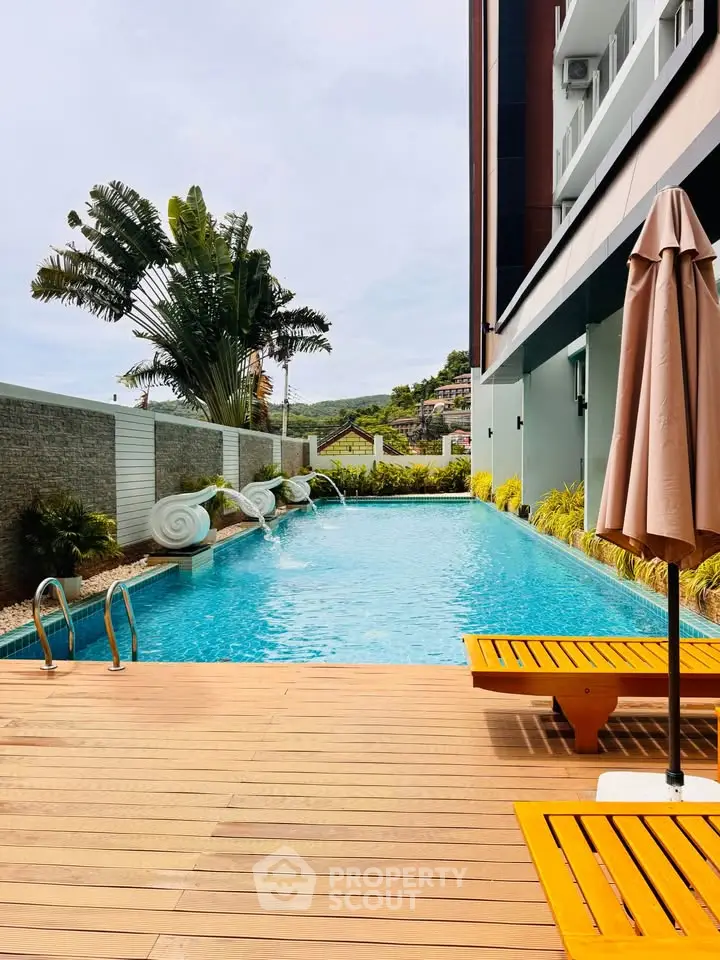 Luxurious poolside area with modern design and lush greenery, perfect for relaxation and leisure.