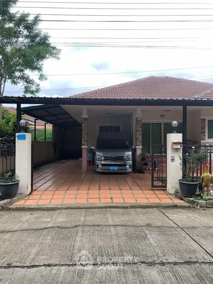 Charming single-story home with covered carport and tiled driveway in a serene neighborhood.