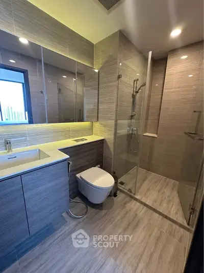 Modern bathroom with sleek design, glass shower, and elegant fixtures in a contemporary home.