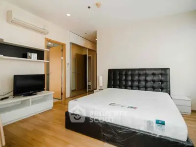 Spacious modern bedroom with sleek furniture and natural light