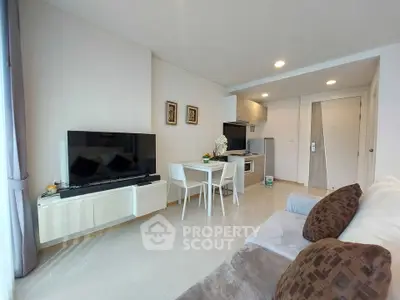 Modern living room with sleek furniture and large TV in a stylish apartment