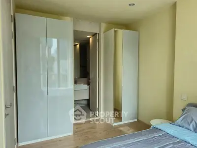 Modern bedroom with ensuite bathroom and sleek wardrobe design
