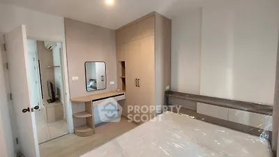 Modern bedroom with built-in wardrobe and stylish vanity in a cozy apartment.