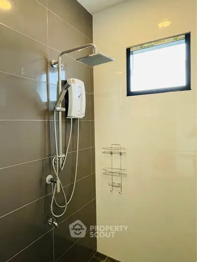 Modern bathroom with sleek shower and natural light window