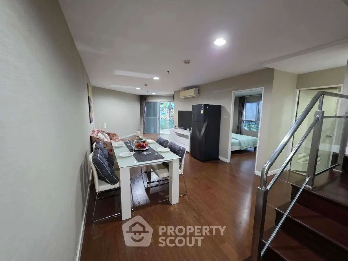 Spacious open-plan living and dining area with modern furnishings and natural light.