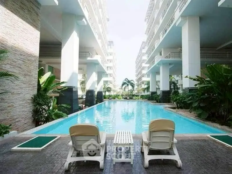 Luxurious apartment complex with stunning pool and lush greenery