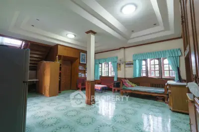 Spacious living room with unique ceiling design and natural light