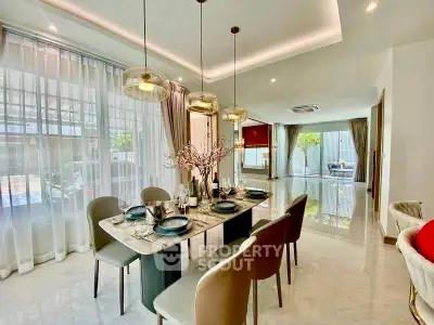 Luxurious dining area with elegant table setting and modern lighting in a spacious open-plan living space.