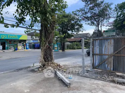 Street view with local shops and residential area, potential for commercial real estate development.