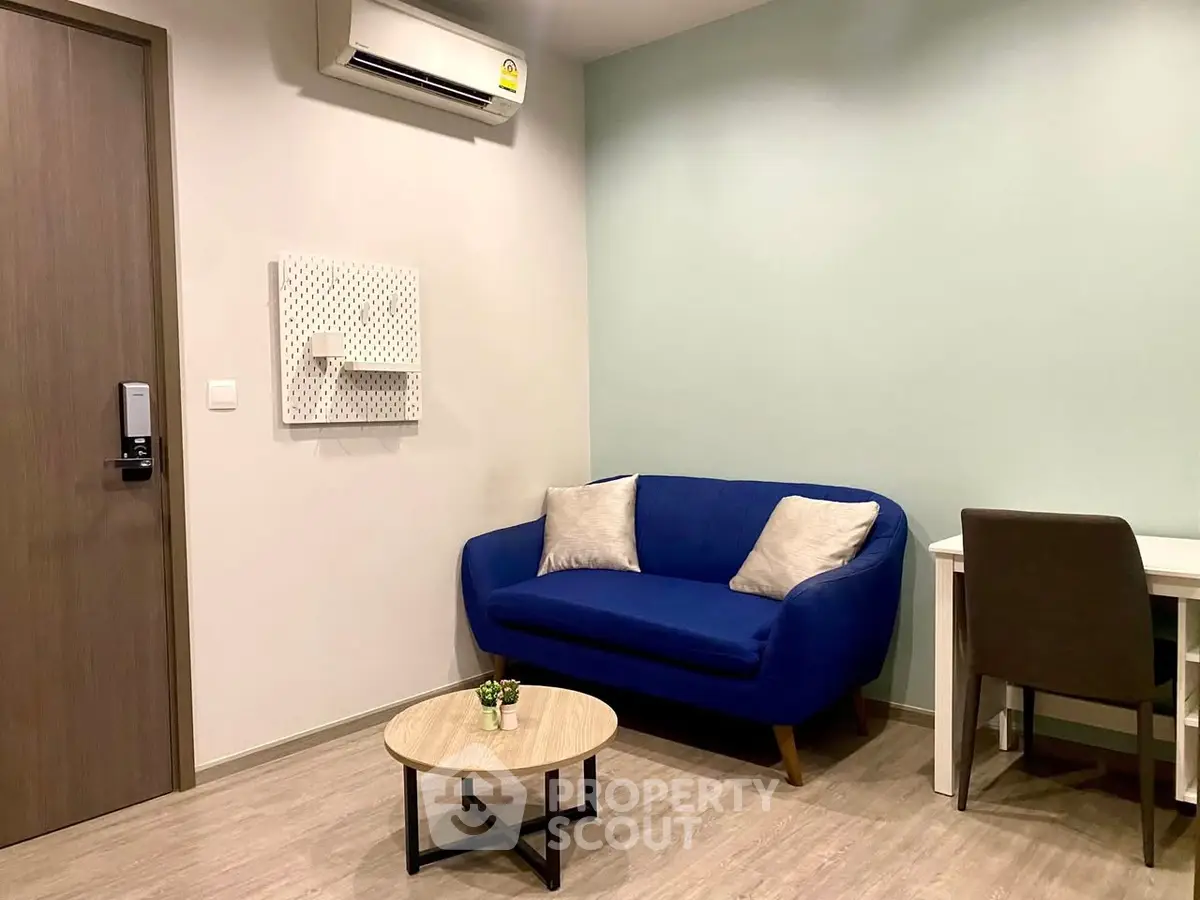 Modern living room with blue sofa and minimalist decor