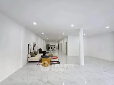 Spacious modern living room with open layout and stylish furniture, perfect for entertaining.