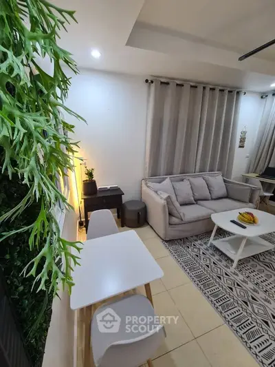 Modern living room with cozy sofa, stylish decor, and indoor plants.