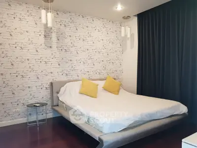 Modern bedroom with stylish brick accent wall and cozy lighting