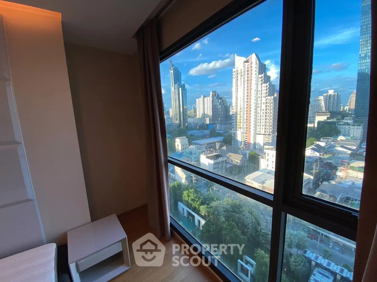Stunning cityscape view from modern high-rise apartment window, showcasing urban skyline and vibrant city life.