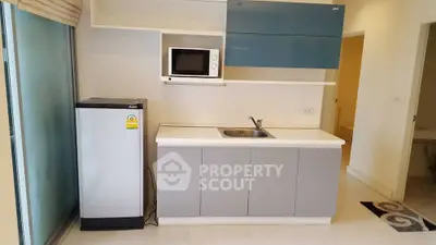 Modern kitchen with sleek cabinetry and built-in microwave