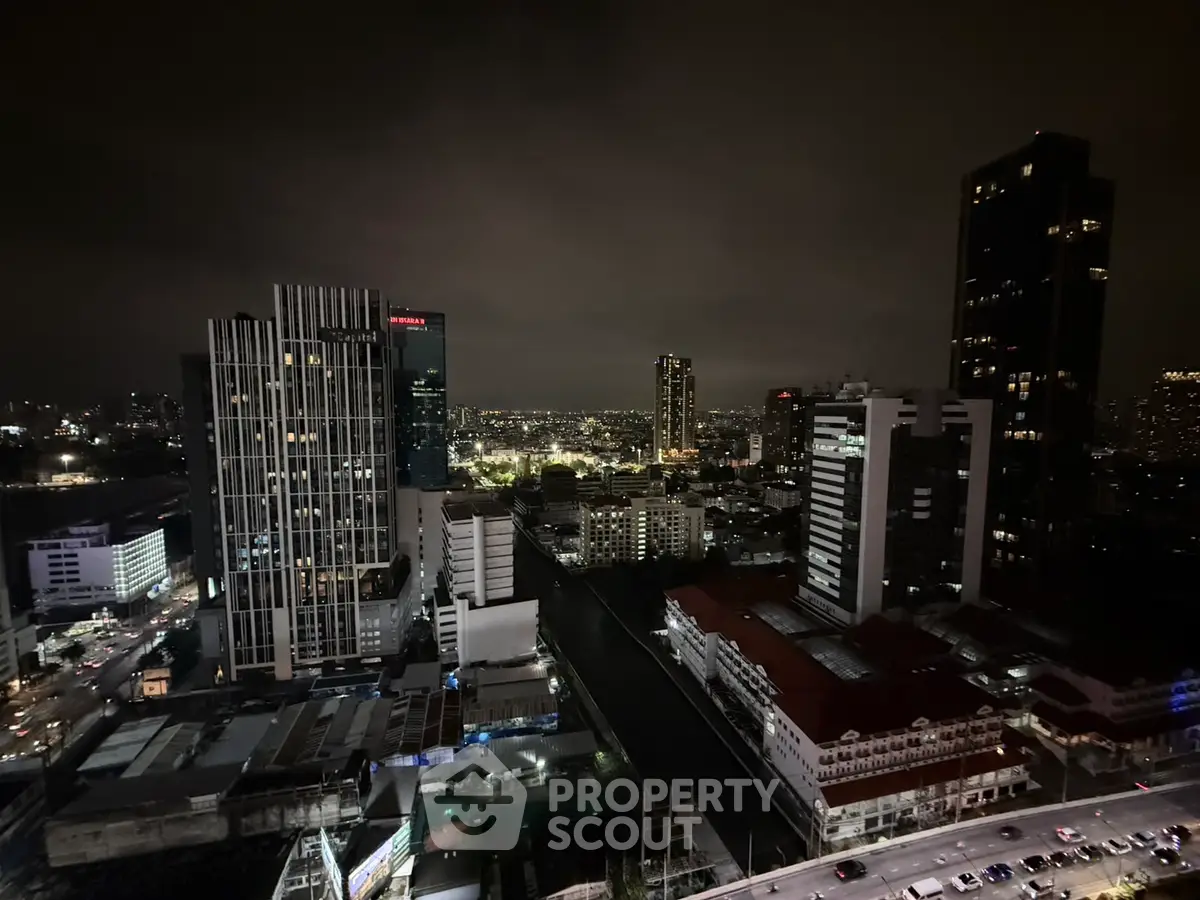 Stunning nighttime cityscape view from high-rise building with illuminated skyline.