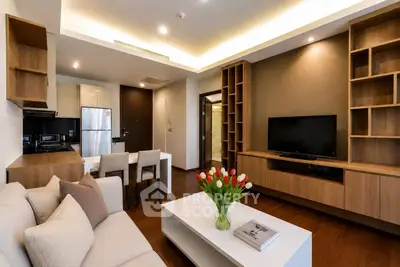 Modern living room with elegant wooden furniture and open kitchen layout