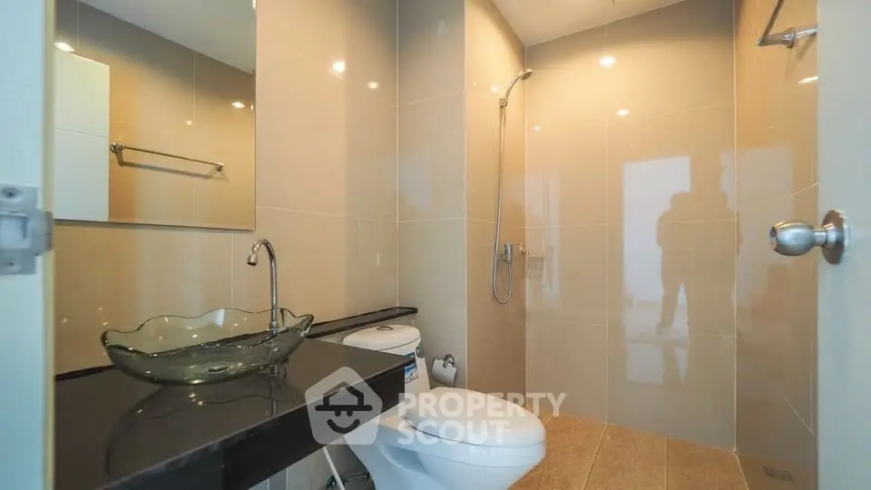 Modern bathroom with glass sink and sleek fixtures