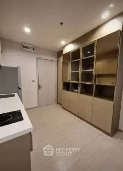 Modern kitchen with sleek cabinetry and built-in appliances in a stylish apartment.