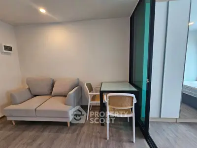 Modern living room with cozy sofa and dining area in a stylish apartment.