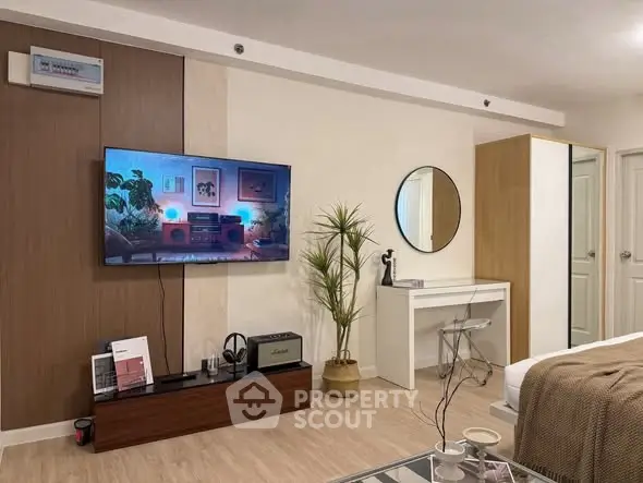 Modern living room with stylish decor and wall-mounted TV, perfect for relaxation and entertainment.