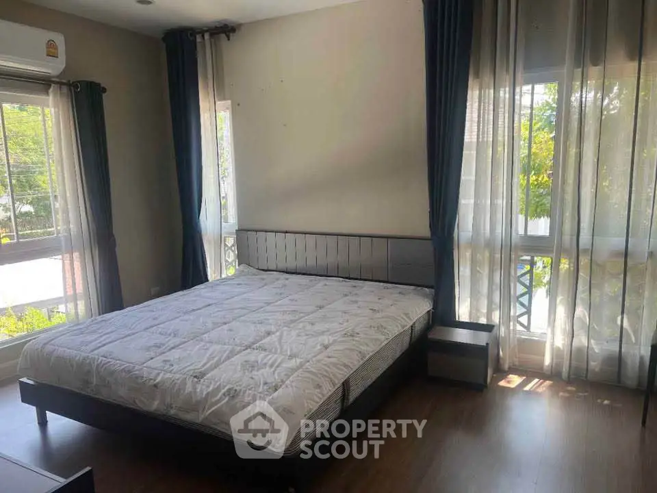 Spacious bedroom with large windows and natural light