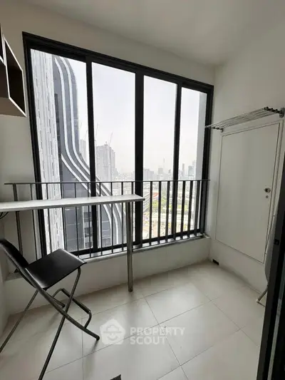 Modern balcony with city view, sleek design, and minimalist furniture in urban apartment.