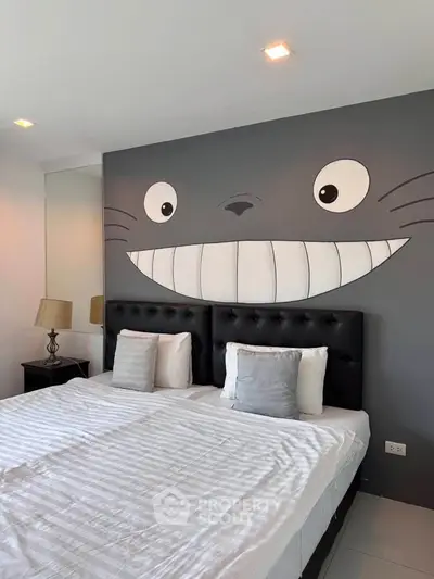 Charming bedroom with playful wall art and cozy twin beds, perfect for a unique living experience.