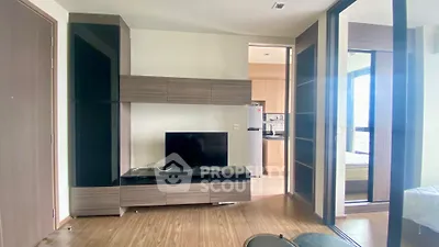 Modern living room with sleek wooden furniture and open kitchen view