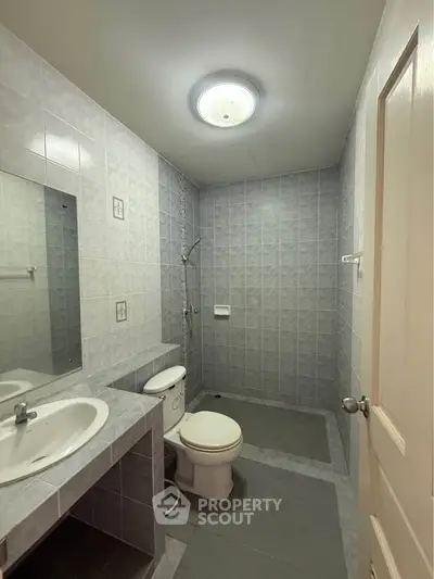 Modern bathroom with sleek gray tiles and contemporary fixtures